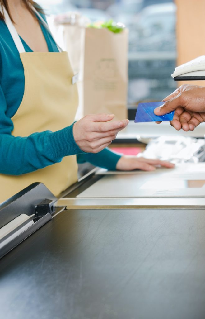 Customer handing a sales assistant a credit card