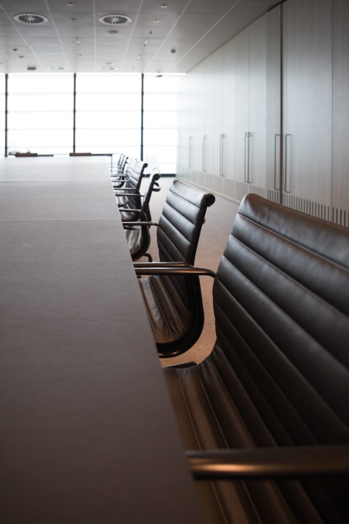Modern large corporate office training conference long timber table board room team meeting room